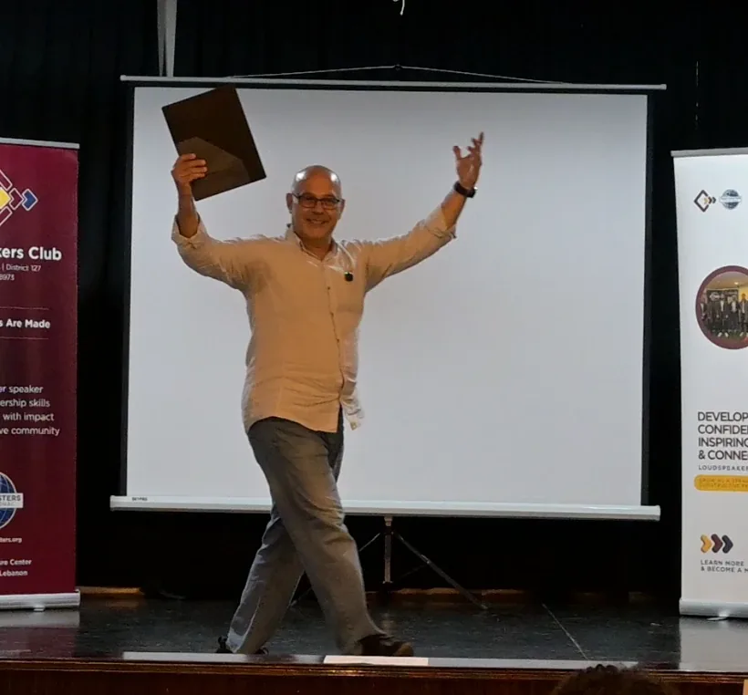 Elio Haddad on stage delivering a talk at a Toastmasters club near Beirut